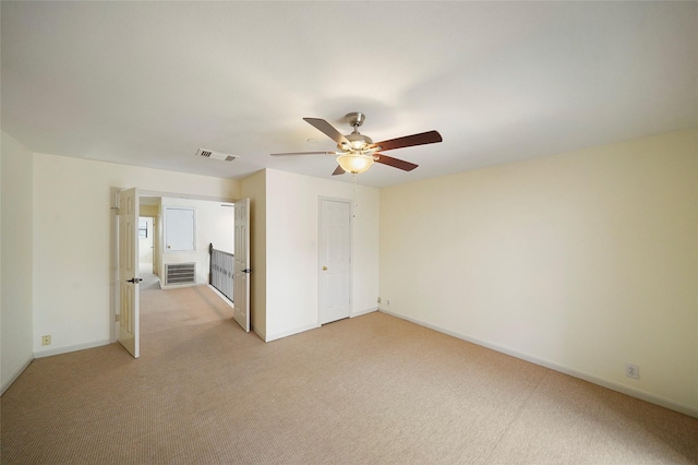 spare room with light carpet and ceiling fan