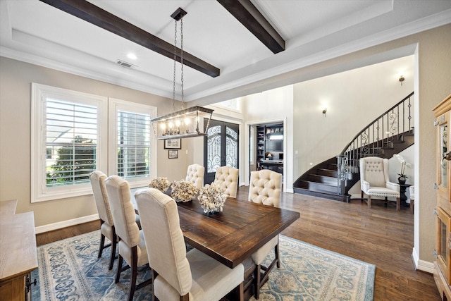 dining space with beam ceiling, dark hardwood / wood-style floors, french doors, and ornamental molding