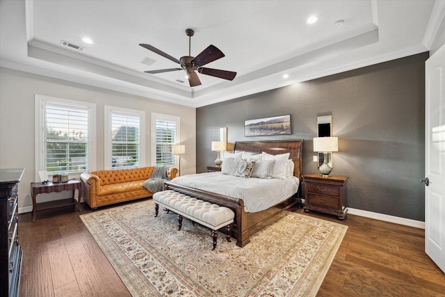 bedroom featuring a tray ceiling, ceiling fan, and ornamental molding