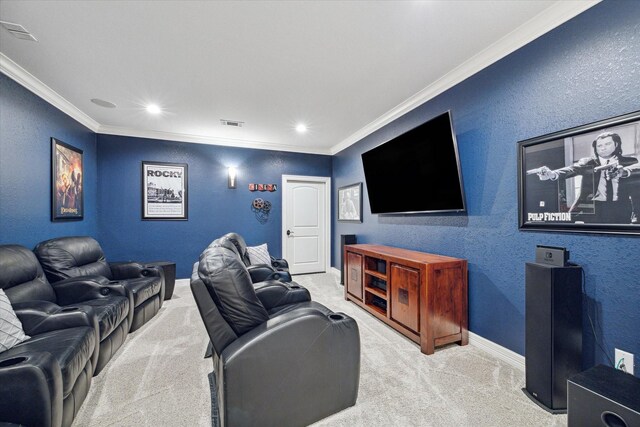 cinema room with crown molding and light colored carpet