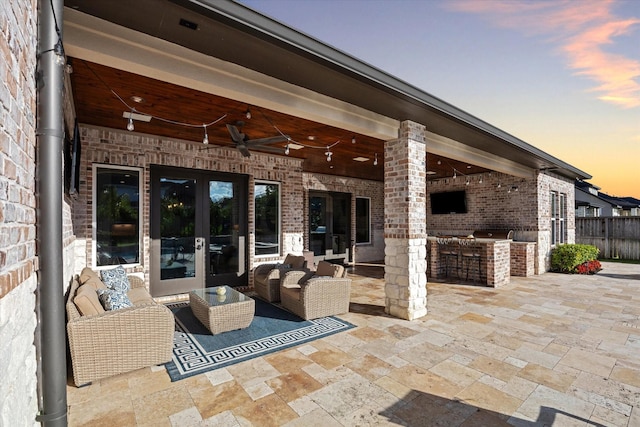 view of patio featuring ceiling fan, exterior kitchen, and french doors