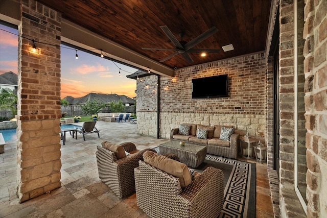 view of patio with an outdoor living space and ceiling fan