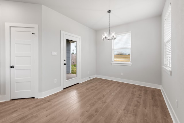 interior space featuring hardwood / wood-style flooring and a chandelier