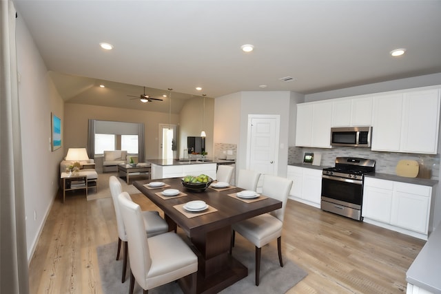 dining room with ceiling fan and light hardwood / wood-style flooring