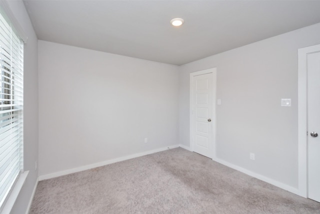 unfurnished room with plenty of natural light and light colored carpet