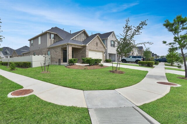 view of front of property with a garage and a front lawn