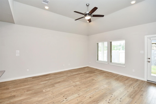 empty room featuring ceiling fan, light hardwood / wood-style flooring, and vaulted ceiling