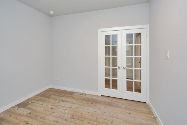 unfurnished room featuring light hardwood / wood-style flooring and french doors