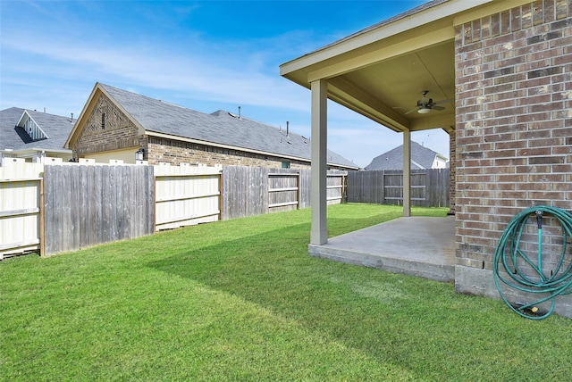 view of yard with ceiling fan and a patio area