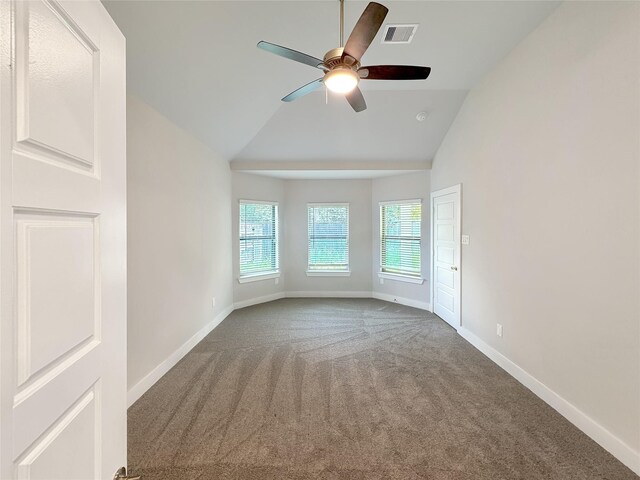 carpeted spare room featuring ceiling fan and vaulted ceiling