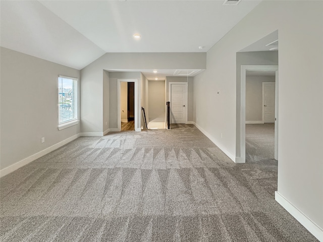 additional living space with carpet flooring and lofted ceiling