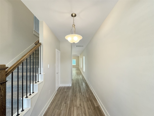 corridor with wood-type flooring