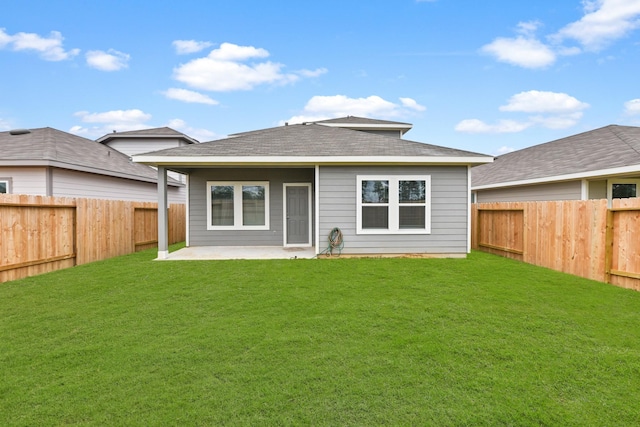 back of house featuring a yard and a patio area