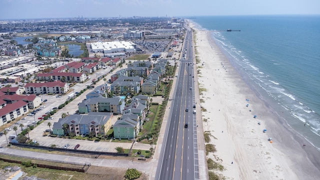 bird's eye view with a water view and a beach view