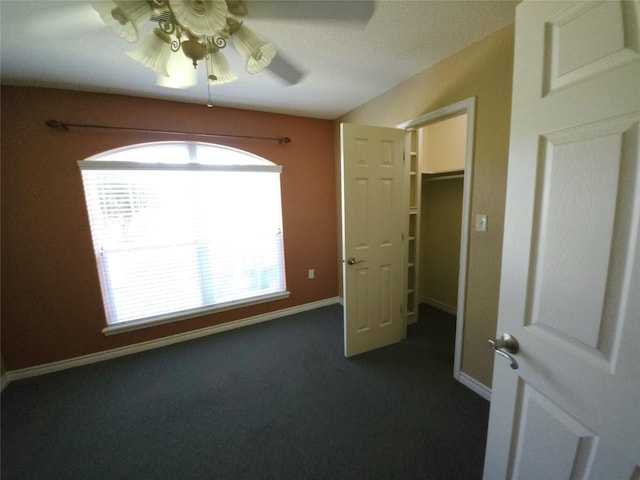 interior space with ceiling fan