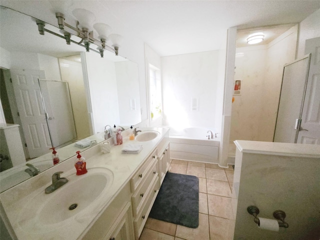 bathroom featuring a tub, tile patterned flooring, and vanity