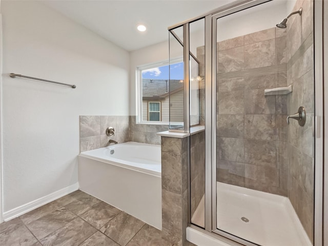 bathroom featuring shower with separate bathtub