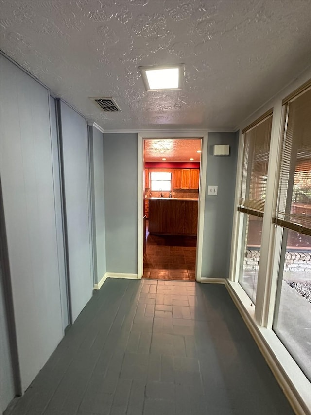 corridor with a textured ceiling