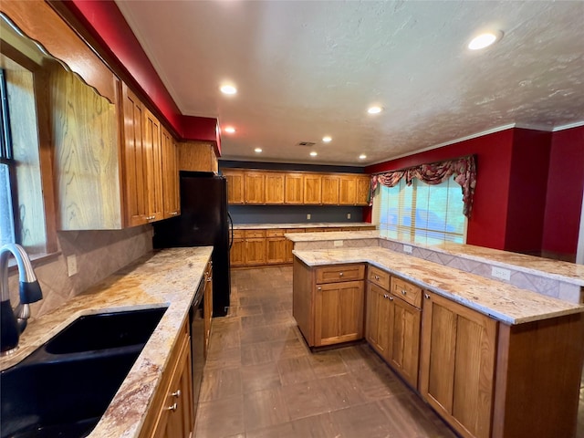 kitchen featuring sink, backsplash, black appliances, and a center island