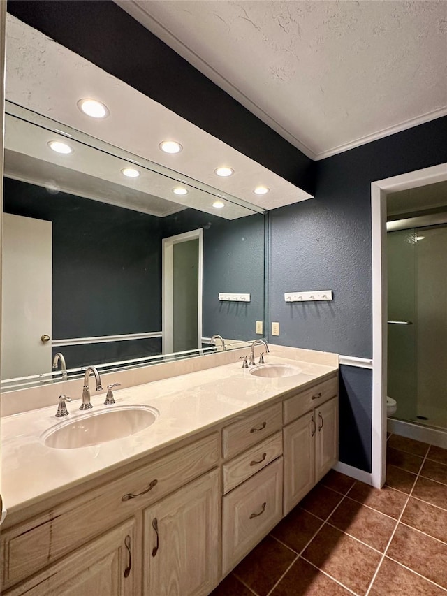 bathroom featuring an enclosed shower, vanity, tile patterned floors, and toilet