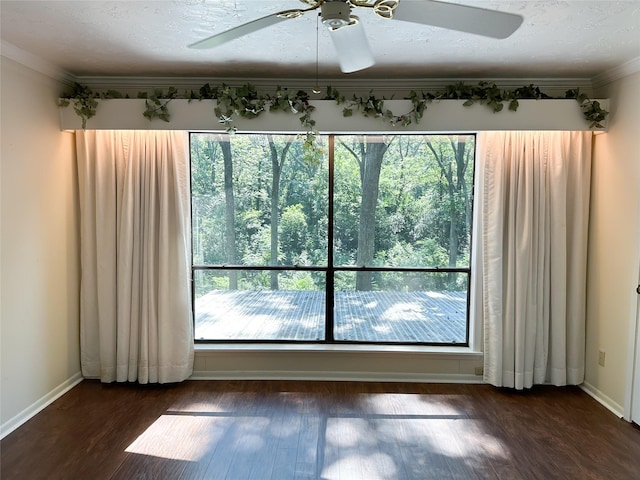 spare room featuring ornamental molding, ceiling fan, a textured ceiling, and dark hardwood / wood-style flooring