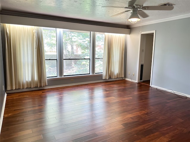 empty room featuring crown molding, plenty of natural light, dark wood-type flooring, and a textured ceiling