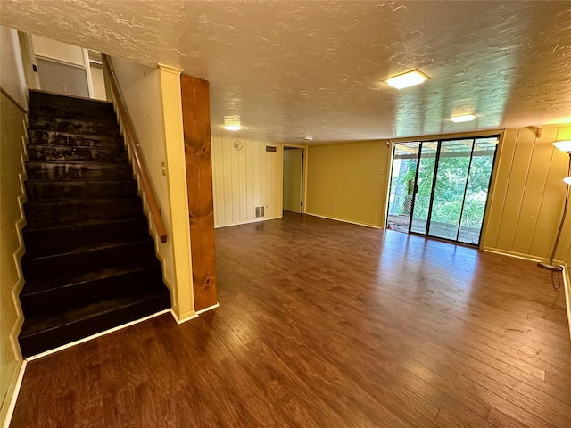 interior space featuring hardwood / wood-style flooring and a textured ceiling