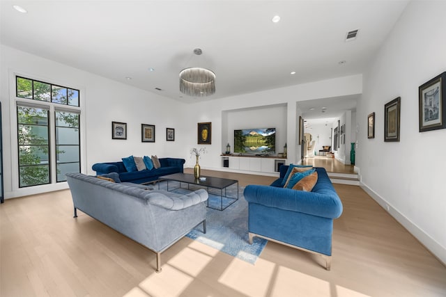 living room featuring plenty of natural light and light hardwood / wood-style flooring