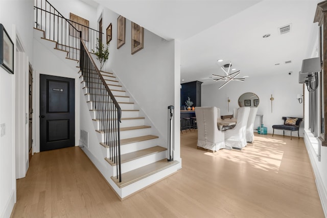 foyer entrance featuring light hardwood / wood-style floors and an inviting chandelier