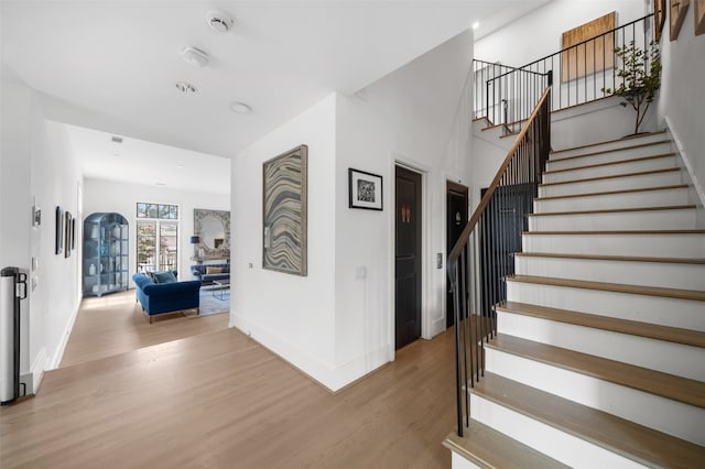 stairs featuring wood-type flooring