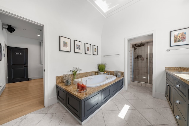 bathroom with vanity, shower with separate bathtub, and hardwood / wood-style floors