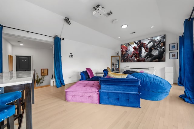 bedroom featuring light hardwood / wood-style floors and lofted ceiling