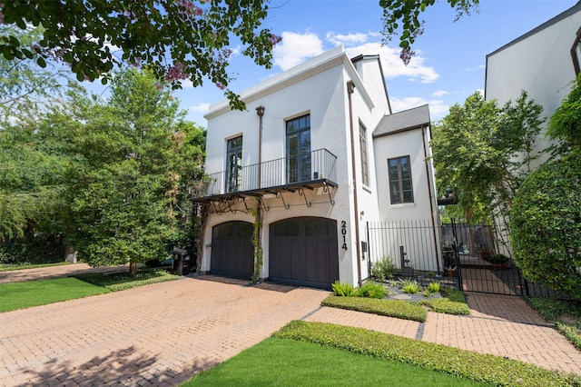 view of front of property with a garage and a balcony