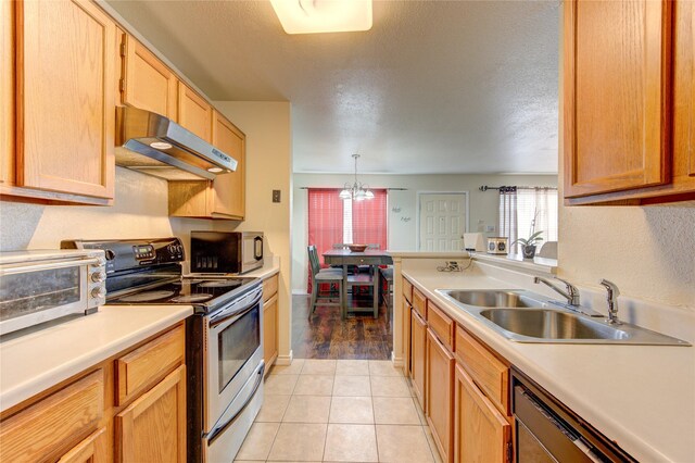 kitchen featuring light tile patterned floors, sink, a textured ceiling, decorative light fixtures, and stainless steel range with electric cooktop