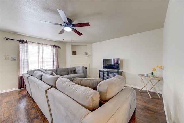 living room featuring a textured ceiling, ceiling fan, and dark hardwood / wood-style floors