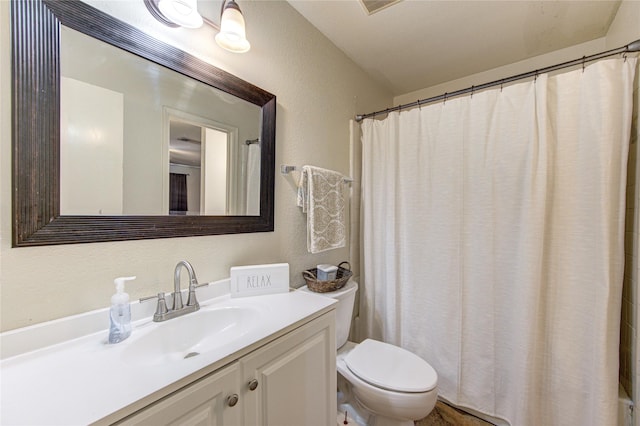 bathroom featuring toilet and vanity