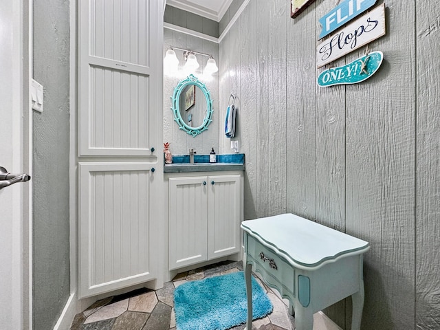 bathroom with wood walls, tile flooring, and vanity