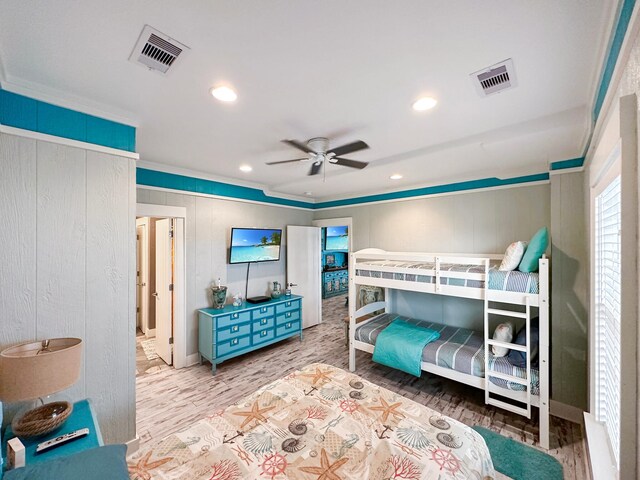 bedroom featuring wood-type flooring, ornamental molding, and ceiling fan