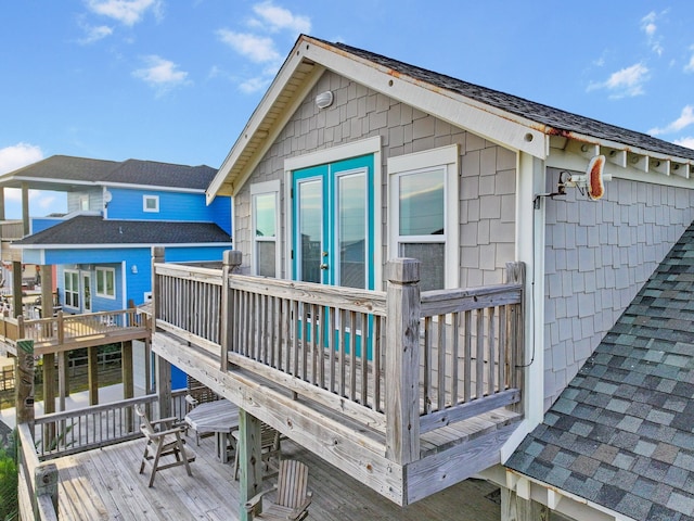 back of property featuring a wooden deck