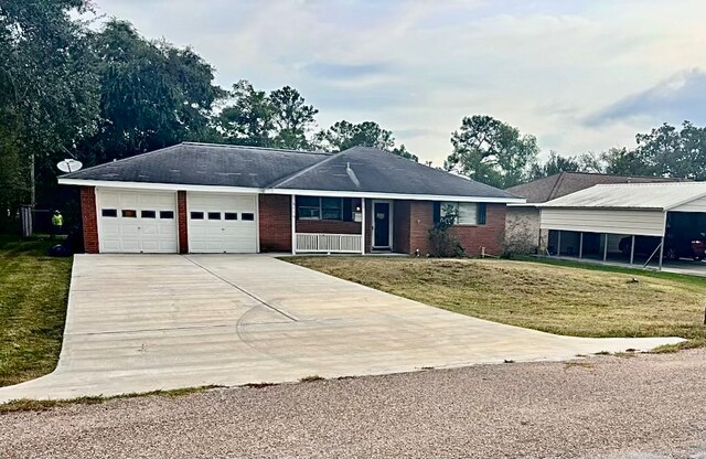 ranch-style house with a garage and a front lawn