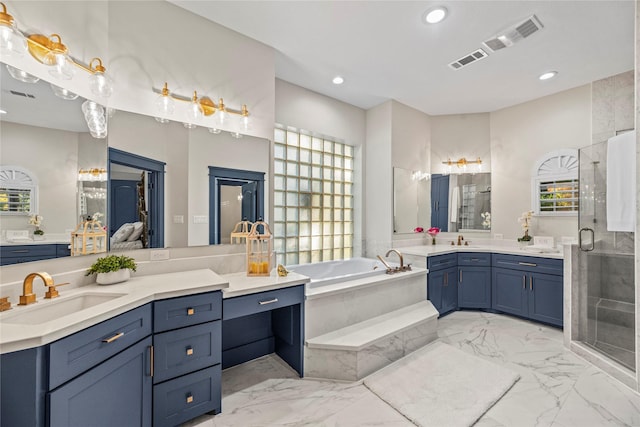 bathroom featuring shower with separate bathtub and vanity