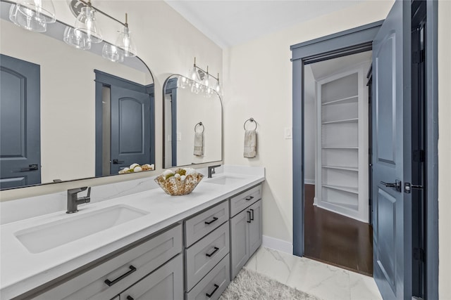 bathroom featuring built in shelves and vanity