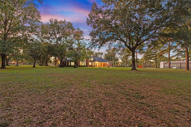 view of yard at dusk