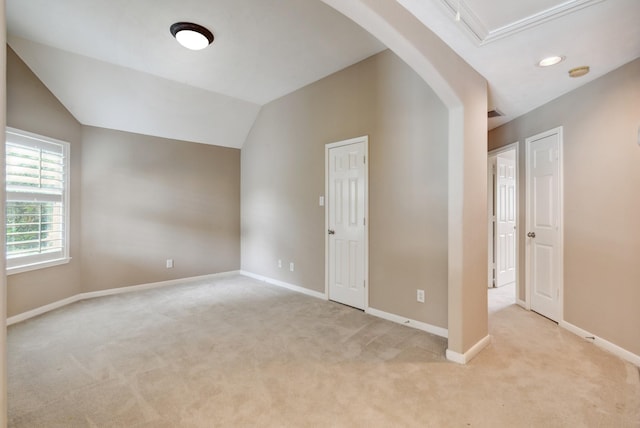 empty room featuring lofted ceiling and light carpet