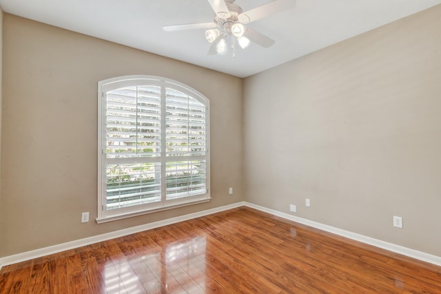 spare room with ceiling fan and hardwood / wood-style flooring