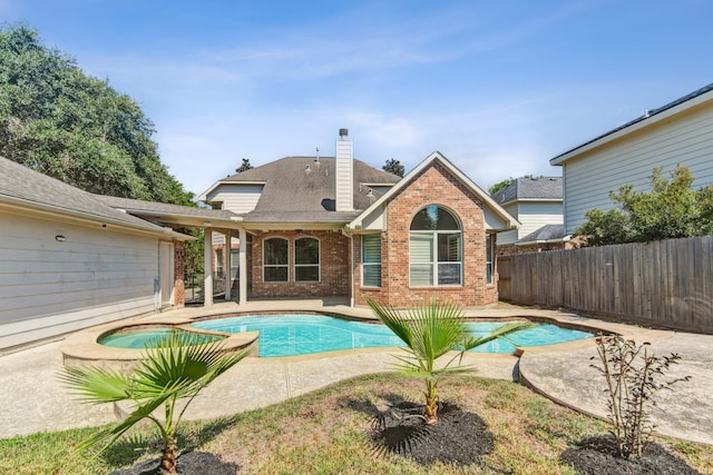 view of swimming pool with an in ground hot tub and a patio area