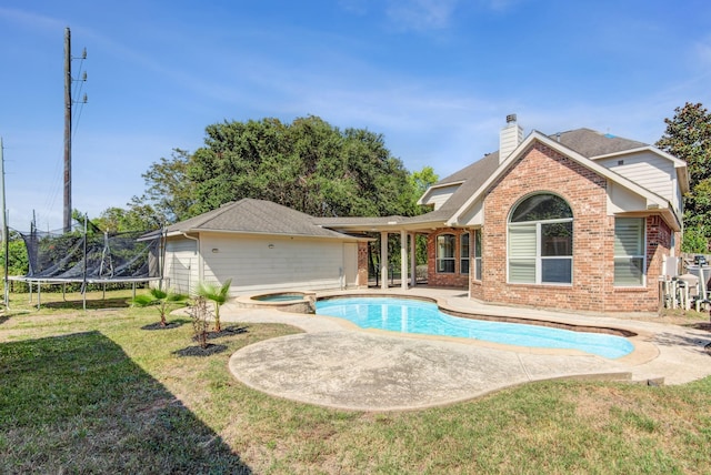 view of pool with a lawn, a patio area, a trampoline, and an in ground hot tub