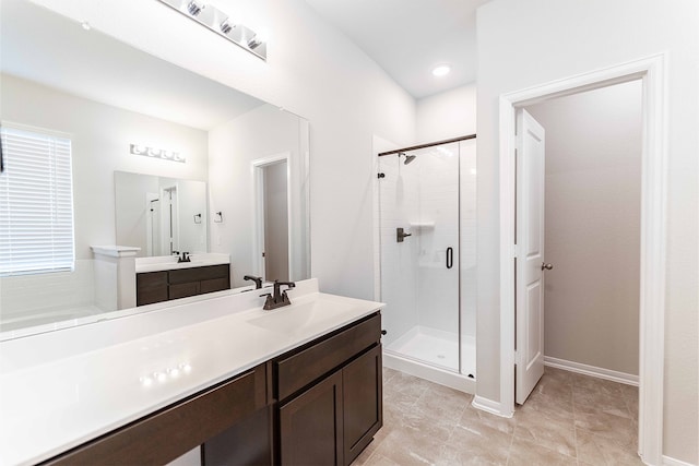 bathroom featuring vanity, a shower with door, and tile patterned floors