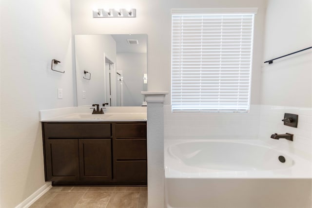 bathroom with vanity, tile patterned floors, and a tub