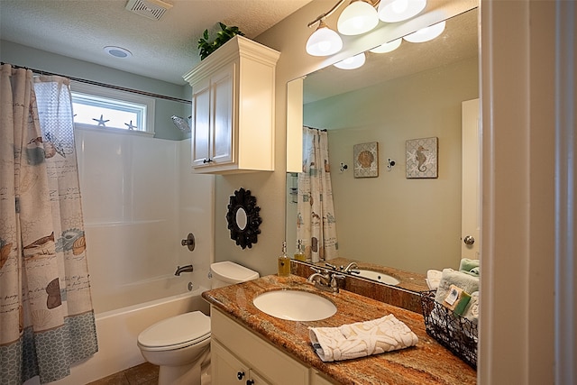 full bathroom with vanity, tile patterned floors, shower / bath combo, toilet, and a textured ceiling